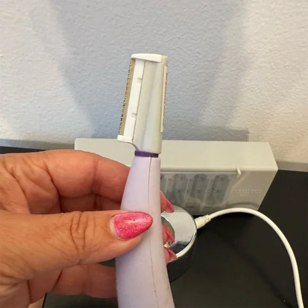 Femme tenant le rasoir sonique