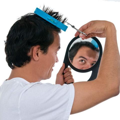 Une homme coupe ses cheveux avec guide coupe cheveux - instacoup en regardant dans le miroire 